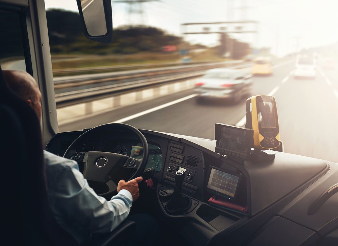 Business Auto Telematics Insurance - Interior of Cab of a Truck With Driver in Motion on a Highway