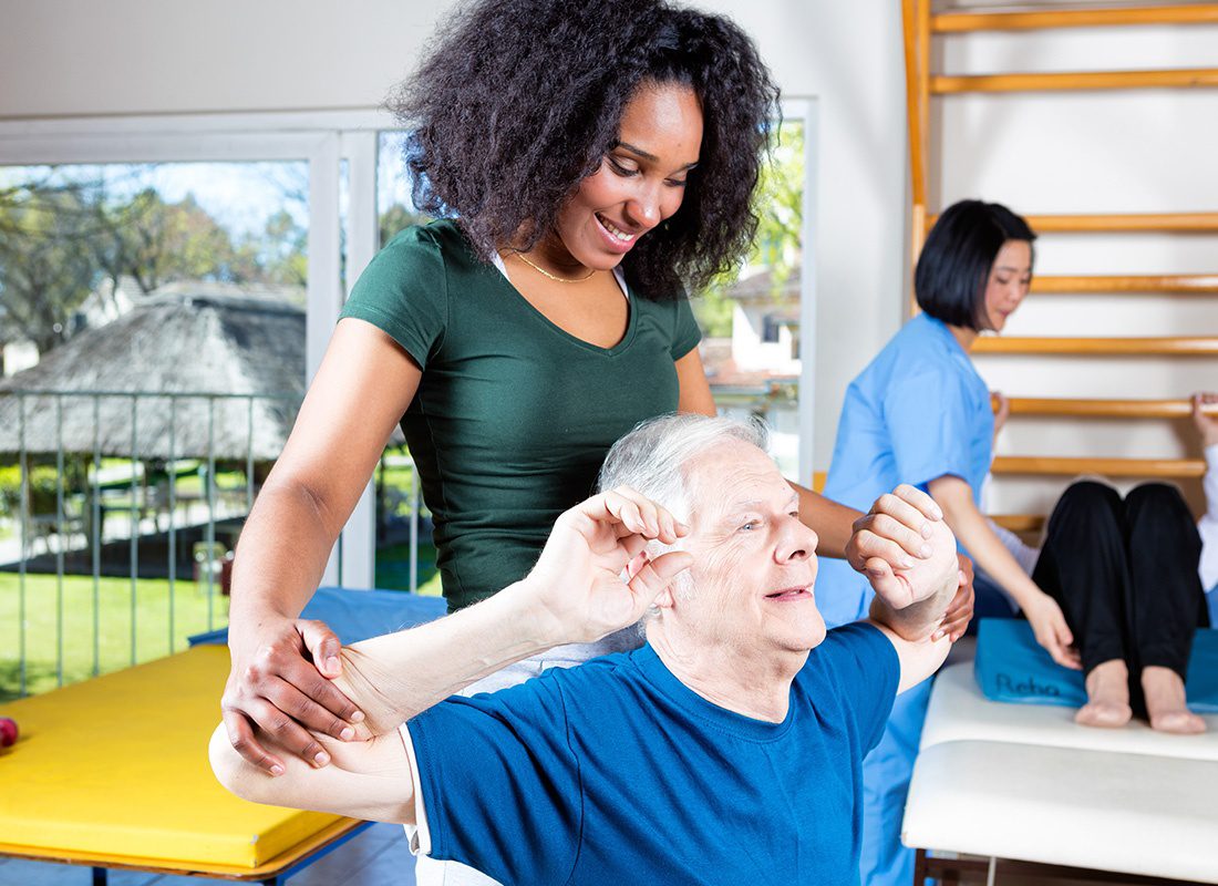 Insurance by Industry - Elderly Man Works Out With a Nurse at a Rehab Center